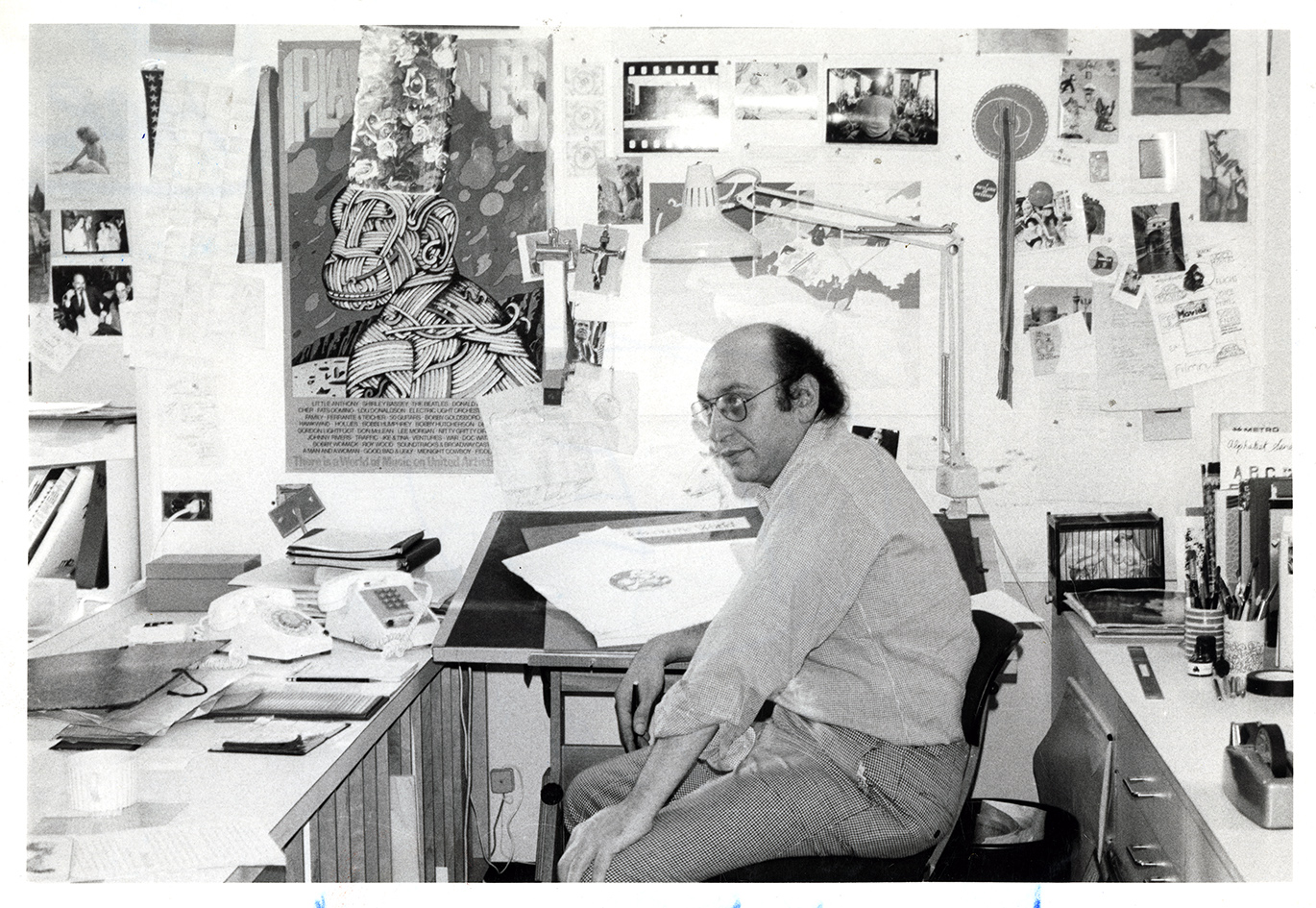Milton sitting at his desk, side view